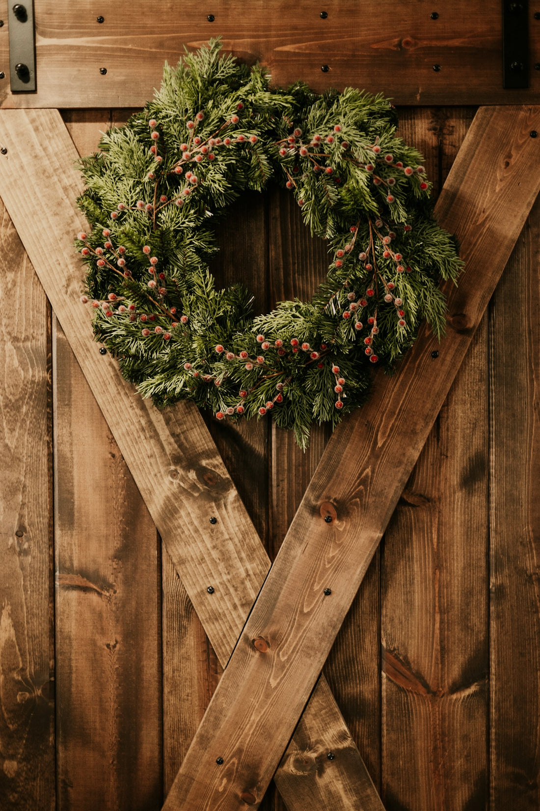 a christmas wreath on a wooden door
